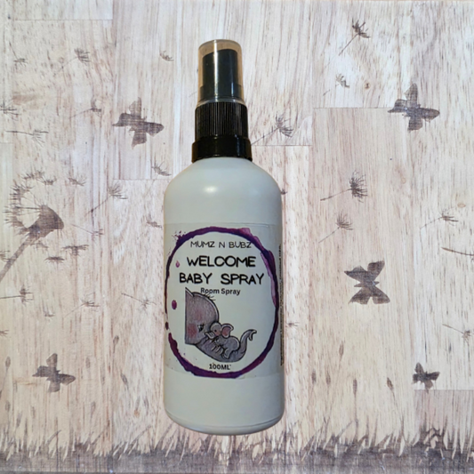 Baby spray bottle with a label on a wooden background with dandelions.