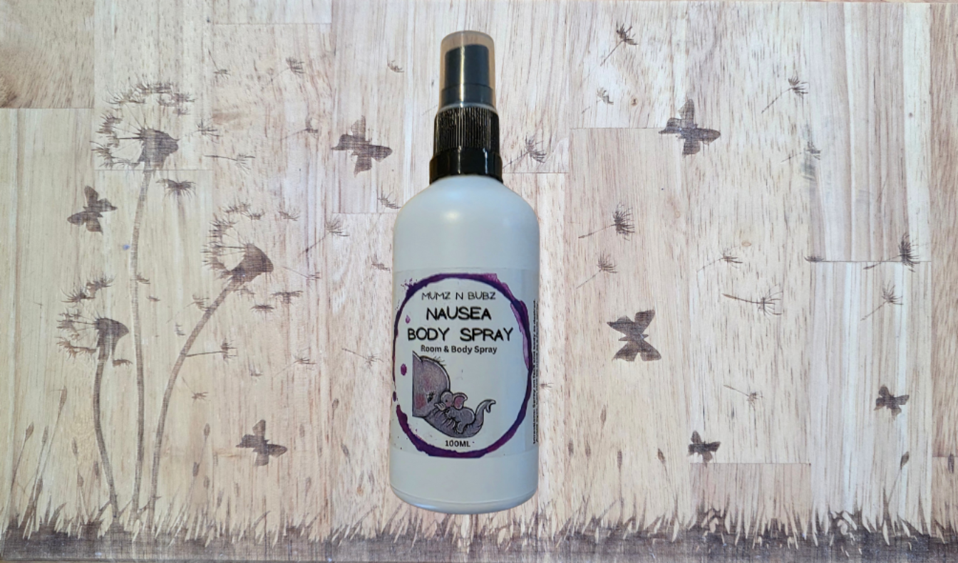Body spray bottle on a wooden background with butterfly decorations